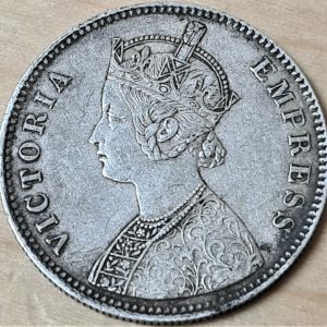 Offered is an original British India 1884 1 Rupee silver coin. We are not coin dealers or experts, so please view photos to determine grade etc. We combine postage on orders.