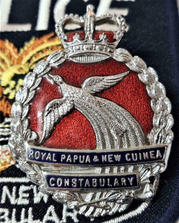 Royal Papua New Guinea Constabulary cap badge and cloth shoulder badges (2)