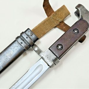 Offered is an original Russian AK-47 bayonet & scabbard. Early type bayonet, featuring wooden grips, curved metal pommel, number stamped 5281, with metal muzzle ring attachment guard. 20cm long with metal blade, showing field sharpening marks to edge, very good overall, which fits nicely into the darkened metal scabbard, which retains the canvas frog and leather fastening straps. Overall length 32.5cm. Service wear and some age to this piece, but good condition overall. This bayonet is from the Rhodesian army collection we are currently selling, so as with many of the other captured pieces in there, I would be certain this is one of those 'souvenired' combat pieces.